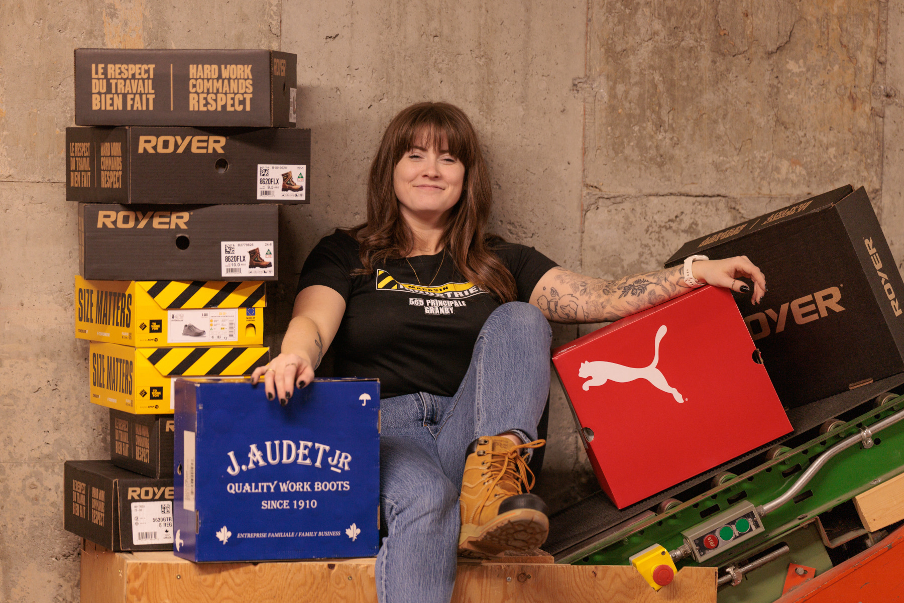 Customer seated among boxes of work footwear